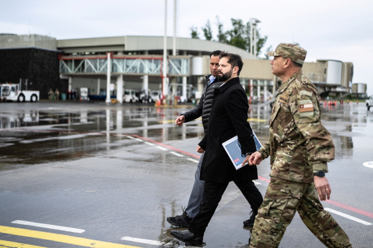 O presidente chileno, Gabriel Boric, caminha com um militar ao chegar à região da Araucanía, em Temuco