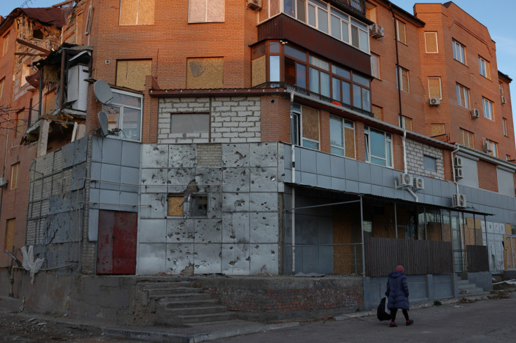 Uma mulher passa por um prédio residencial danificado, enquanto o ataque da Rússia à Ucrânia continua, em Mykolaiv