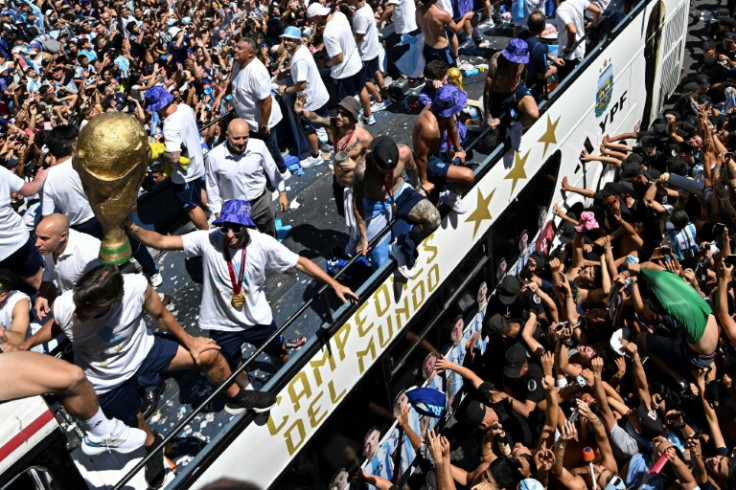 Torcedores da Argentina torcem em Buenos Aires enquanto a seleção desfila a bordo de um ônibus após a vitória na Copa do Mundo de 2022 no Catar