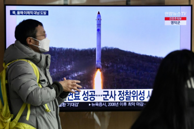 Um homem passa por uma tela de televisão mostrando um noticiário com imagens de arquivo de um teste de míssil norte-coreano, em uma estação ferroviária em Seul, em 31 de dezembro de 2022, depois que a Coreia do Norte disparou três mísseis balísticos de cu