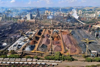 An expansive industrial mining facility with machinery and slag heaps